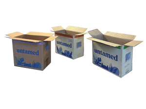 Three cardboard boxes with various print and 'untamed' branding on a white background