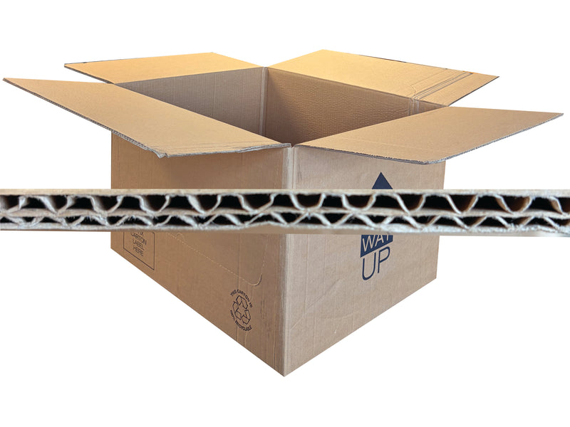 An open brown corrugated cardboard box with flaps raised, shown on a white background with a close-up horizontal strip of the cardboard wall in front of it.